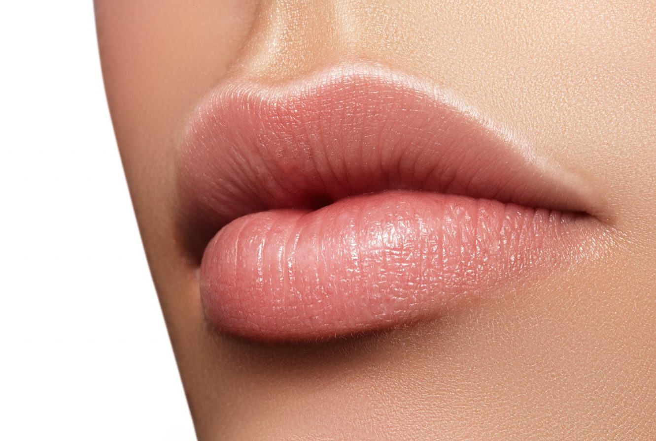 Close-up perfect natural lip makeup beautiful female mouth. Plump sexy full lips. Macro photo face detail. Perfect clean skin, fresh lip make-up. Beautiful spa tender lips. Blank Space
